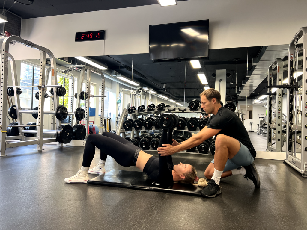 Personal trainer coaching a client through a strength exercise in Vancouver