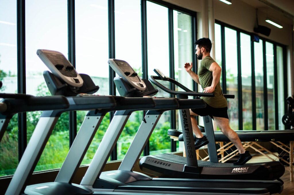 Personal trainer working with a client in a downtown Vancouver gym overlooking Coal Harbour